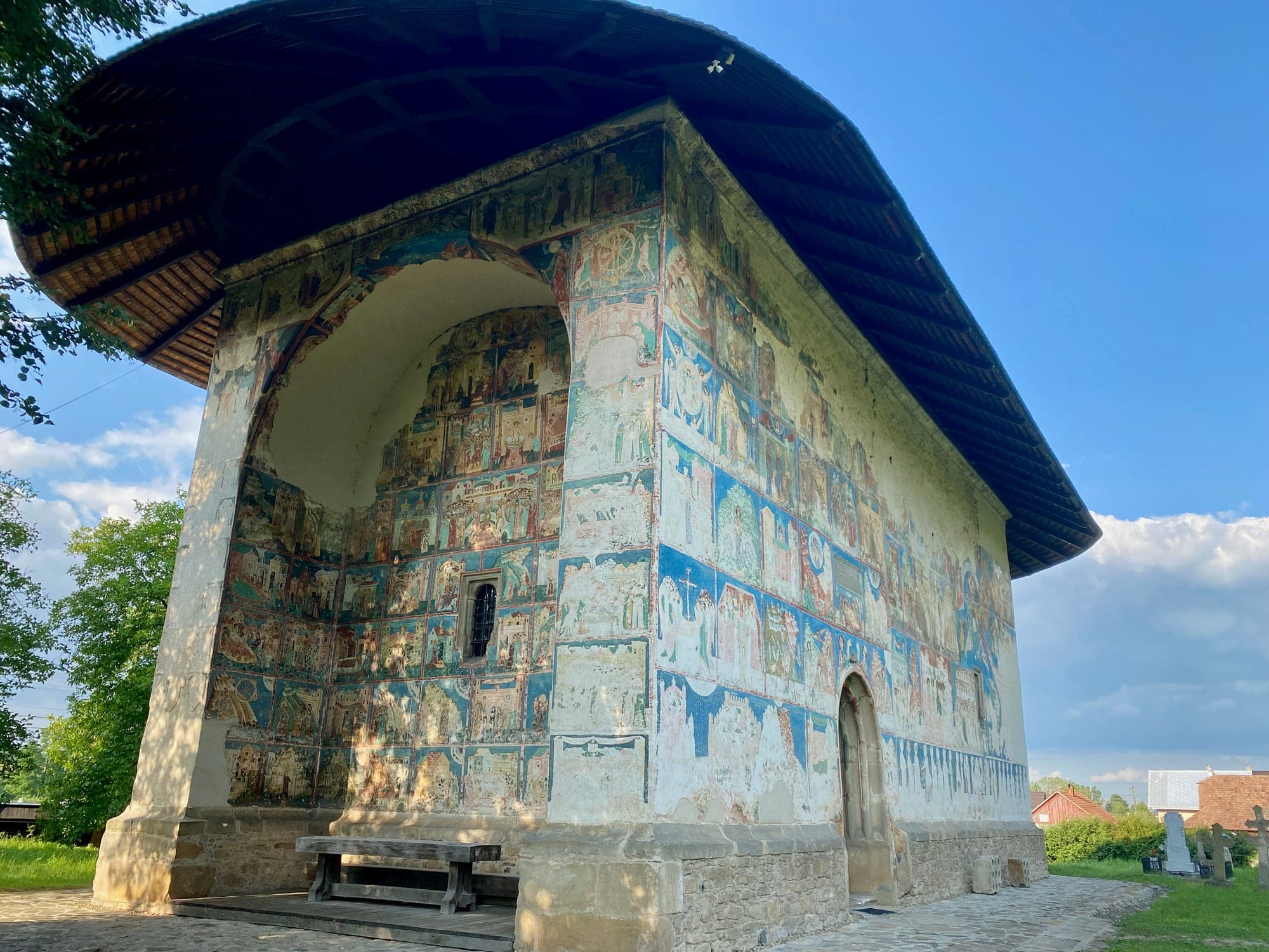 Arbore Church seen from the south-west, with the painted niche of the west facade and the frescoes of the south facade under the wide eaves