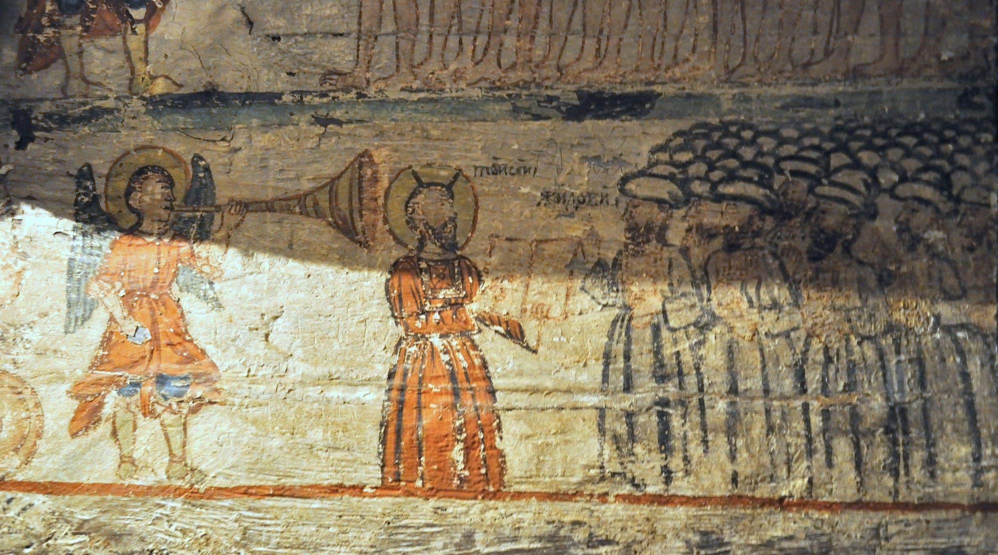 Detail of the mural painting on wood: an angel blowing a trumpet before a row of figures