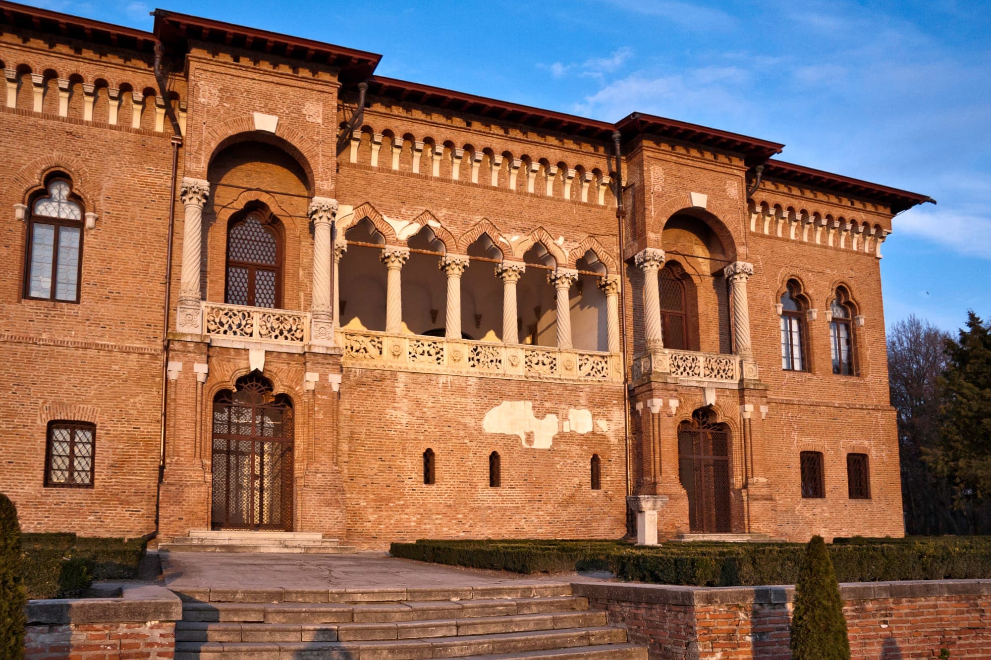 The loggia with twisted columns and carved stone balustrade on the south front, in the sunset light