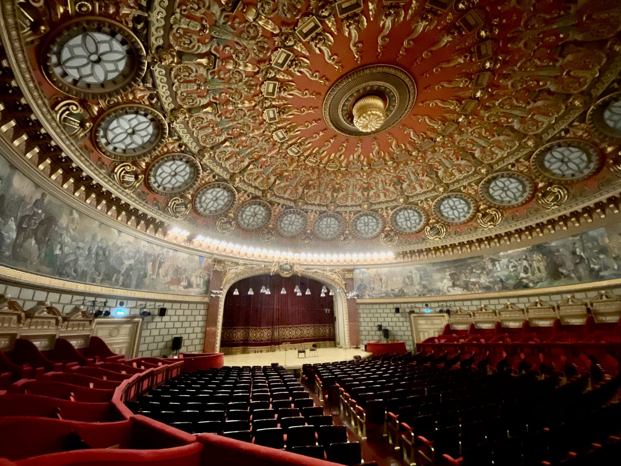 The concert hall, with its gilded ceiling, the fresco around the walls, the stage and the red seats